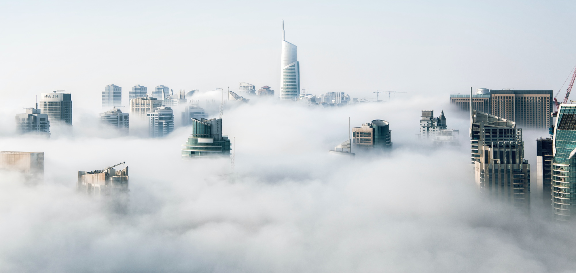 City skyline rising above the clouds